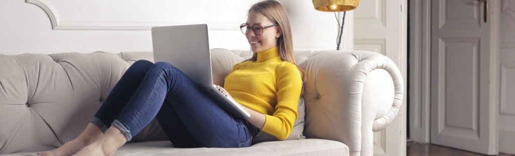 Girl with laptop on sofa